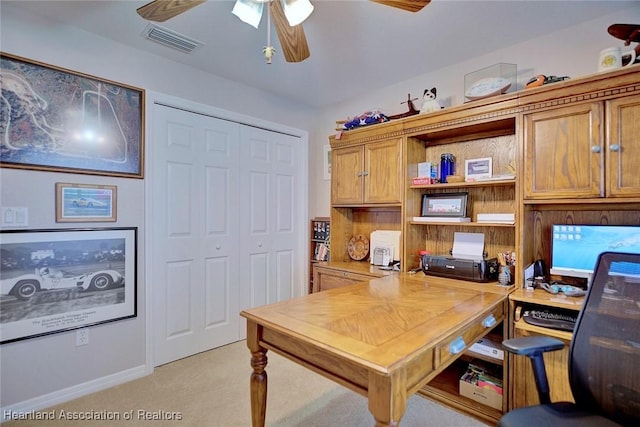 carpeted office space with ceiling fan