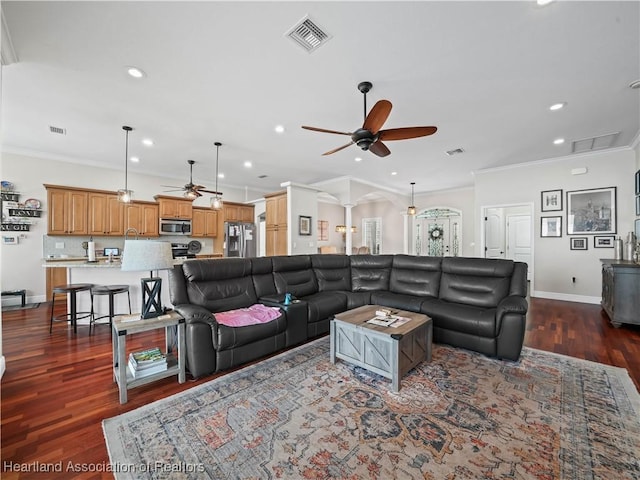 living room with ceiling fan, dark wood-type flooring, and ornamental molding