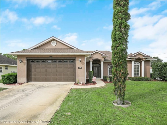 single story home featuring a garage and a front yard