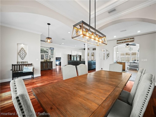 dining area featuring ceiling fan, wood-type flooring, and crown molding