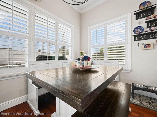 dining area featuring plenty of natural light, dark hardwood / wood-style flooring, and crown molding