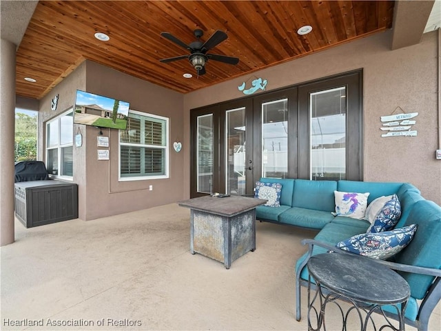 view of patio / terrace featuring an outdoor living space, ceiling fan, and french doors