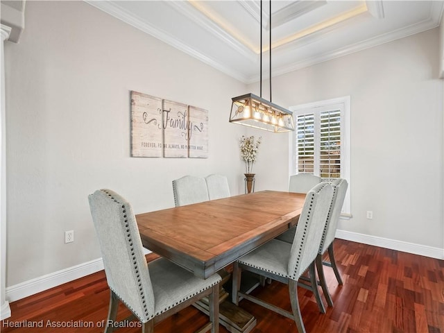 dining space featuring crown molding, dark hardwood / wood-style floors, and a tray ceiling