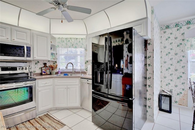 3171 E Pebble Dr, Avon Park, FL 33825 - kitchen featuring white cabinets, ceiling fan, wallpapered walls, appliances with stainless steel finishes, and a sink