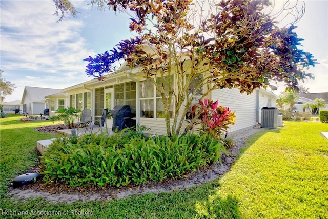 3171 E Pebble Dr, Avon Park, FL 33825 - view of property exterior featuring central air condition unit and a yard