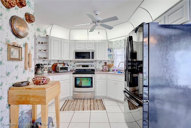 3171 E Pebble Dr, Avon Park, FL 33825 - kitchen featuring open shelves, freestanding refrigerator, stainless steel range with electric stovetop, wallpapered walls, and white microwave
