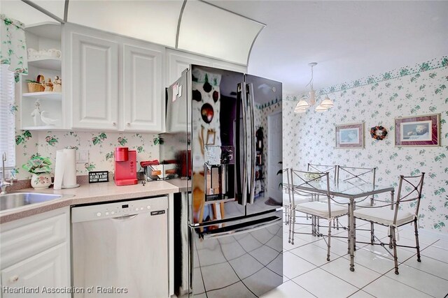 kitchen featuring sink, ceiling fan, light tile patterned floors, white cabinetry, and stainless steel appliances