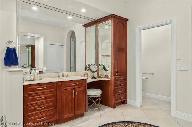 bathroom featuring tile patterned floors, crown molding, and vanity