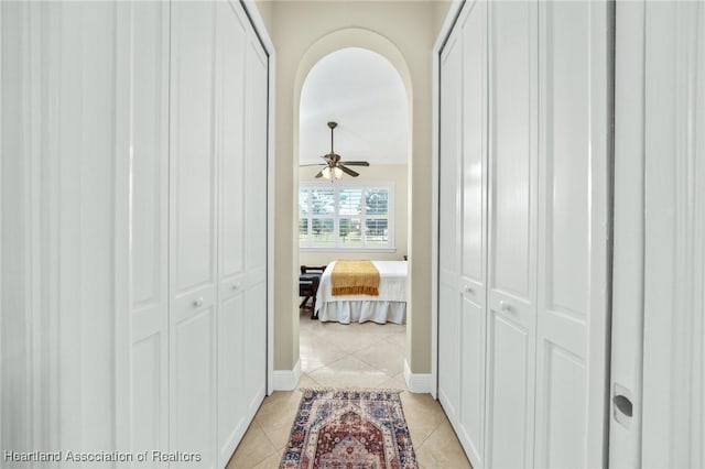 hall with light tile patterned floors