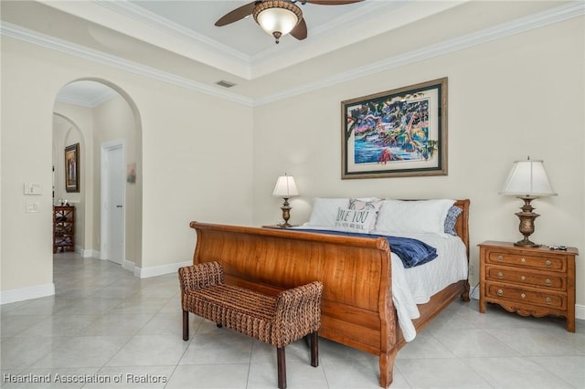 tiled bedroom with a tray ceiling, ceiling fan, and crown molding