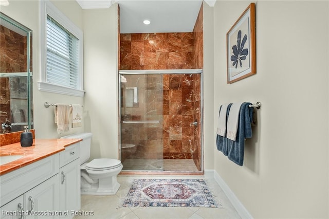 bathroom with tile patterned floors, vanity, toilet, and a shower with door