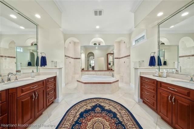 bathroom with vanity, a relaxing tiled tub, and ornamental molding