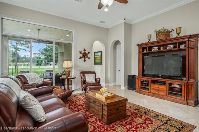 living room featuring light tile patterned floors, ceiling fan, and crown molding