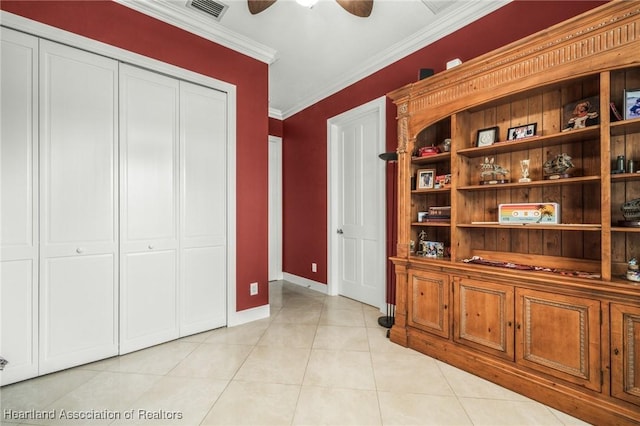 interior space with light tile patterned floors and crown molding