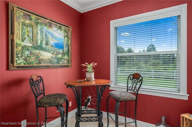 dining space with plenty of natural light and crown molding