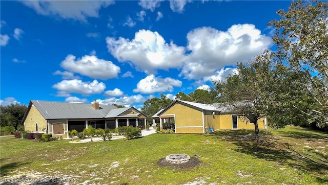 exterior space with a yard and a fire pit