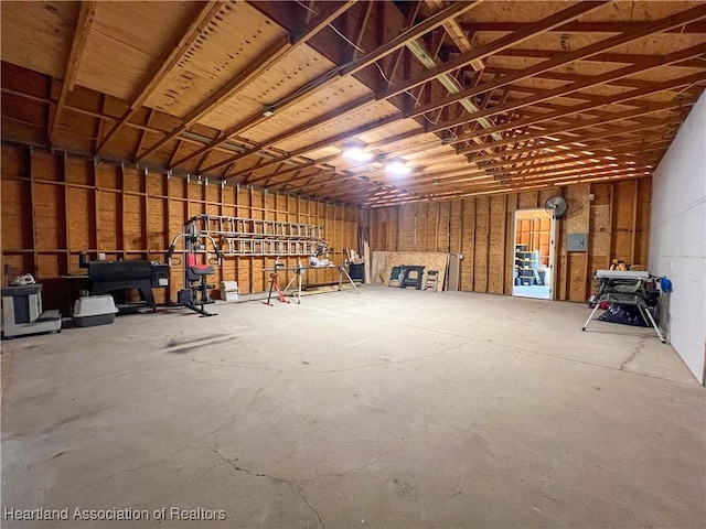 miscellaneous room with a workshop area and concrete floors