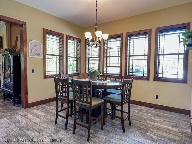 dining area featuring a chandelier and hardwood / wood-style flooring