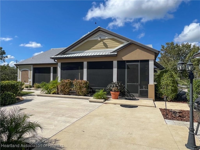 back of house featuring a sunroom