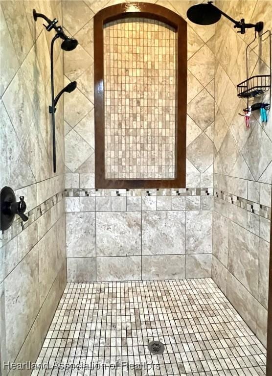 bathroom with a tile shower