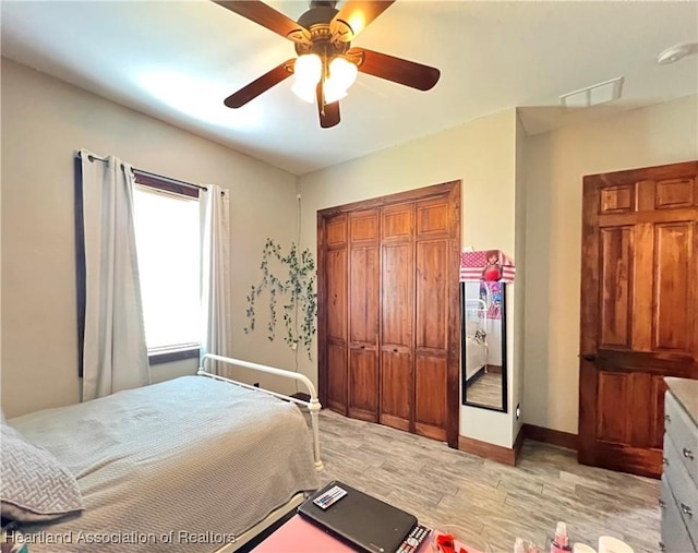 bedroom with light wood-type flooring and ceiling fan