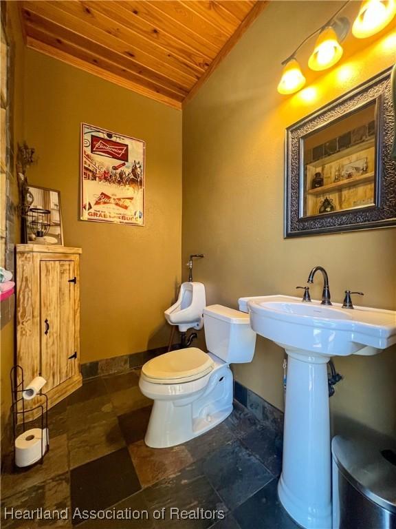 bathroom featuring wood ceiling, lofted ceiling, and toilet