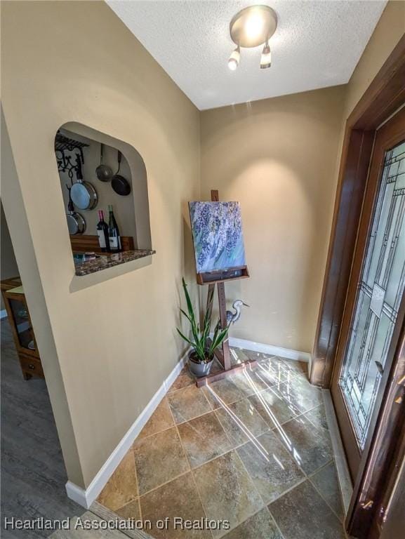 foyer entrance featuring a textured ceiling