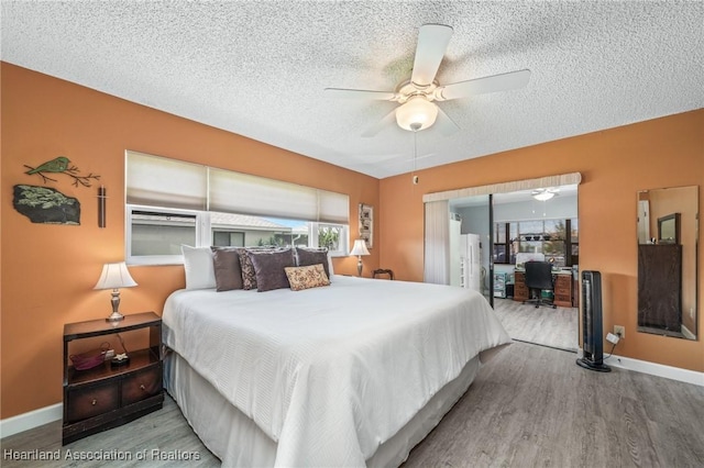 bedroom featuring a textured ceiling, hardwood / wood-style flooring, and ceiling fan