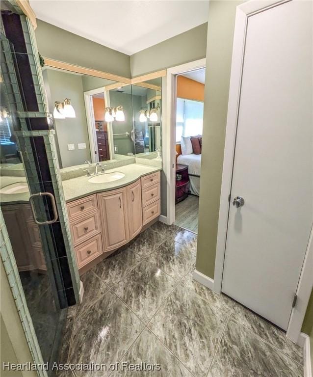 bathroom featuring vanity and a shower with door