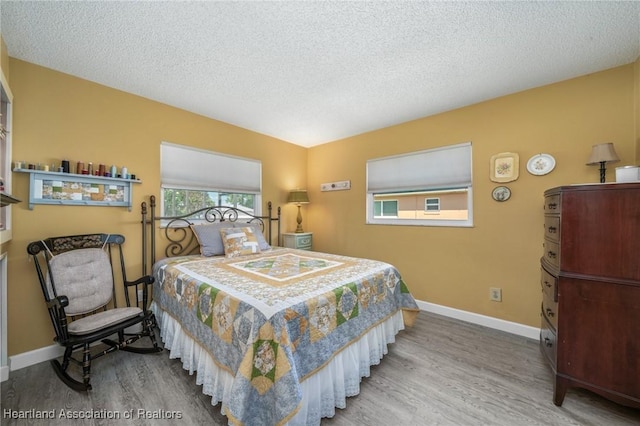 bedroom featuring a textured ceiling and hardwood / wood-style flooring