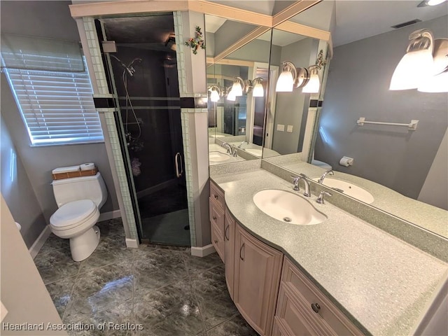 bathroom with vanity, an enclosed shower, and toilet