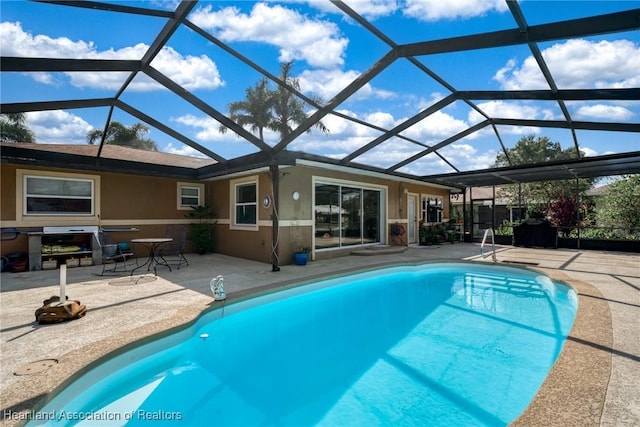 view of pool with a lanai and a patio