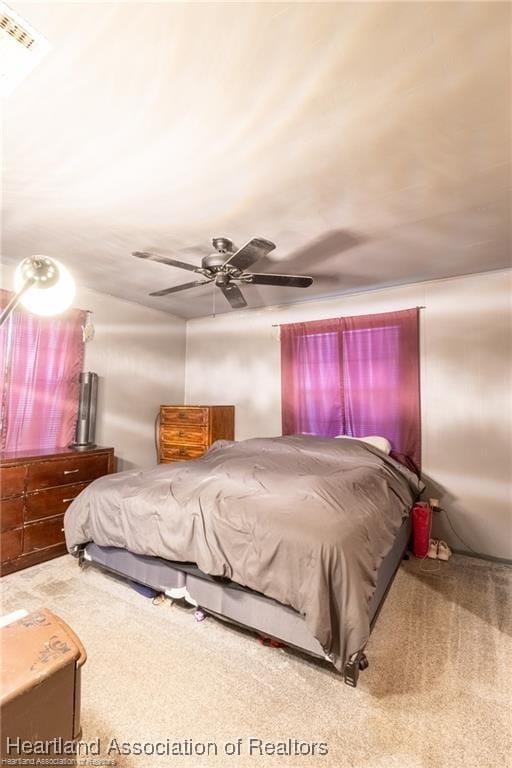 bedroom featuring ceiling fan and carpet