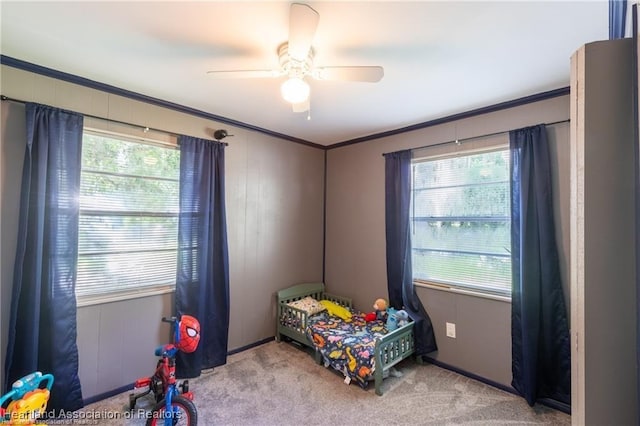 bedroom featuring multiple windows, light colored carpet, and ornamental molding