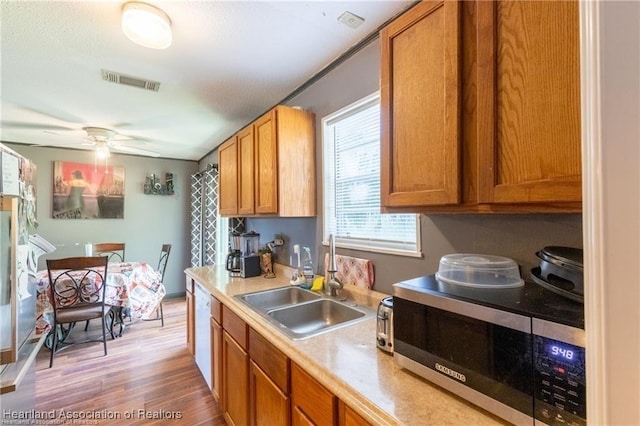 kitchen featuring light wood-type flooring, sink, and ceiling fan