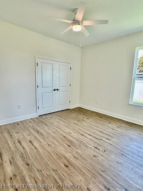5279 Pebble Dr, Sebring, FL 33872 - unfurnished bedroom featuring baseboards, ceiling fan, wood finished floors, and a closet