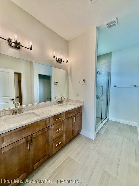5279 Pebble Dr, Sebring, FL 33872 - full bath with a sink, a stall shower, double vanity, and visible vents