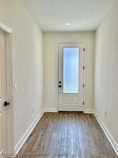 5279 Pebble Dr, Sebring, FL 33872 - doorway to outside with baseboards and wood finished floors