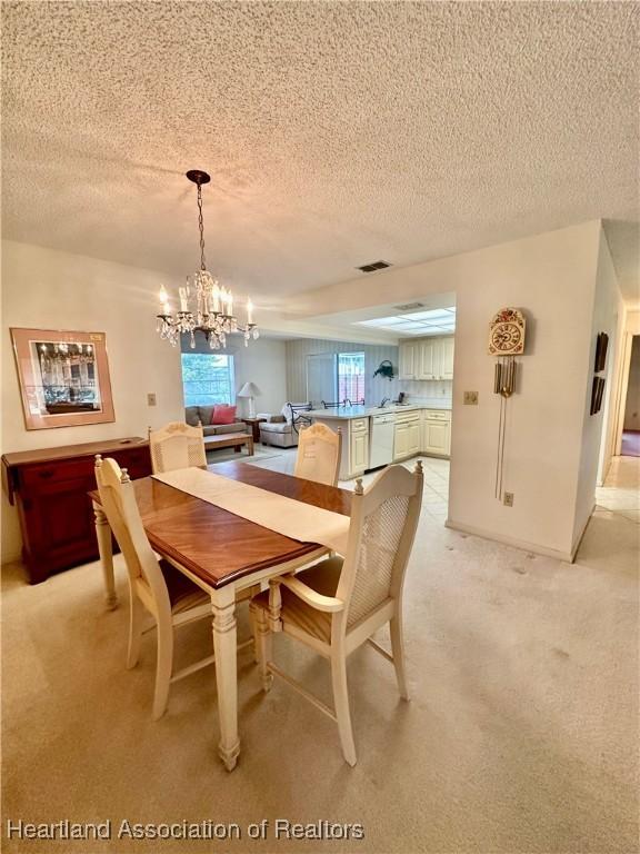1704 Palm St, Sebring, FL 33870 - dining space with a chandelier, a textured ceiling, and light carpet
