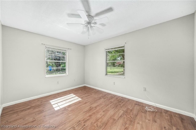 empty room featuring ceiling fan and hardwood / wood-style flooring