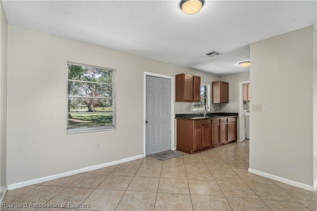 kitchen featuring sink and light tile patterned flooring