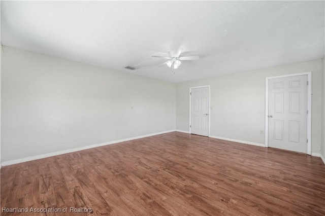 unfurnished room featuring dark hardwood / wood-style floors and ceiling fan