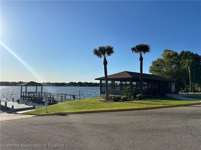 dock area featuring a yard and a water view