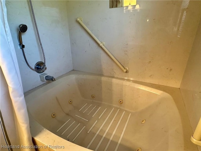 full bathroom featuring a tub with jets
