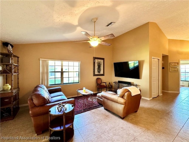 living area featuring visible vents, a ceiling fan, a textured ceiling, baseboards, and vaulted ceiling