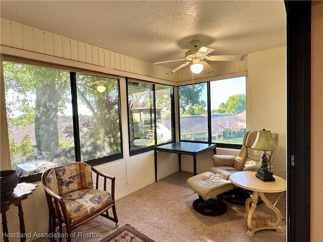 sunroom featuring a ceiling fan