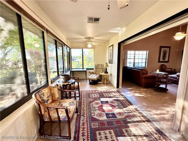 sunroom featuring visible vents and ceiling fan