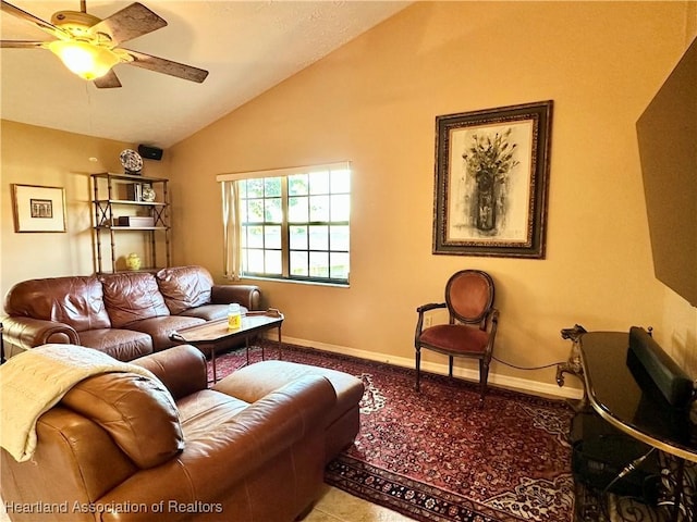 living room featuring baseboards, a ceiling fan, and vaulted ceiling