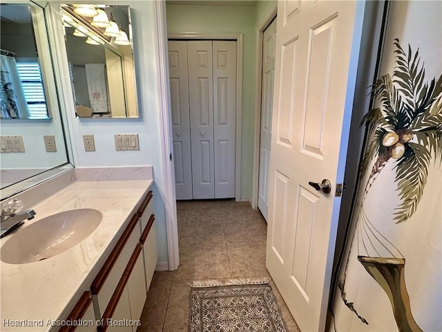 bathroom with tile patterned flooring and vanity