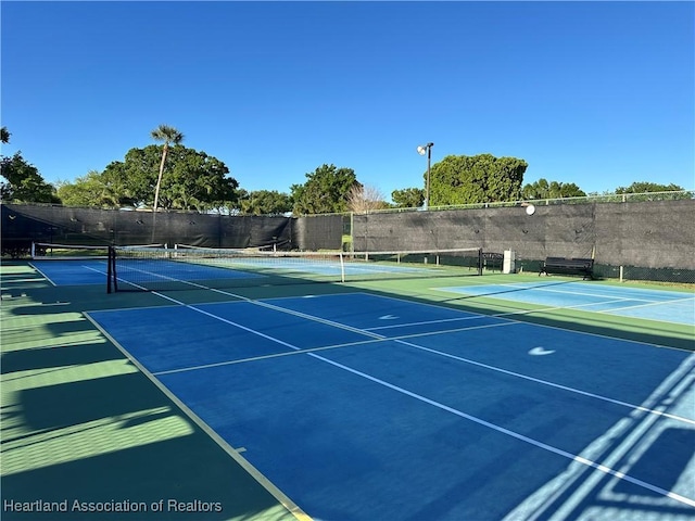 view of tennis court with fence